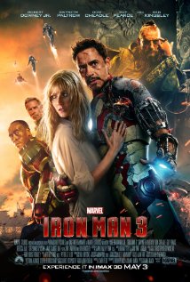 Poster for Iron Man 3: Tony Stark in damaged armor holds Pepper Potts, the cast behind them