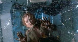 Still from The Lost World: Jurassic Park: a woman pressed against the cracking glass window of the dangling RV