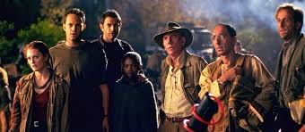 Still from The Lost World: Jurassic Park: the expedition team stands together in a dark jungle at night
