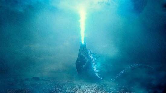Still from Godzilla: King of the Monsters: Godzilla fires atomic breath into a blue haze
