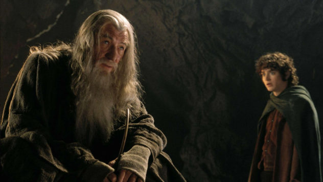 Still from The Fellowship of the Ring: Gandalf sits in the dark of Moria as Frodo stands beside him