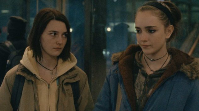 Still from Never Rarely Sometimes Always: two teenage girls in winter coats on a city street