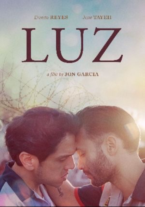 Poster for Luz: two men rest their foreheads together before a razor-wire fence