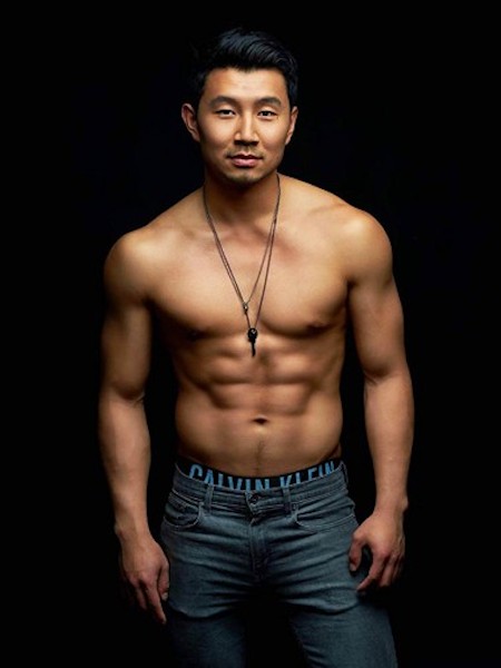 Simu Liu, star of Shang-Chi, poses shirtless against a black background