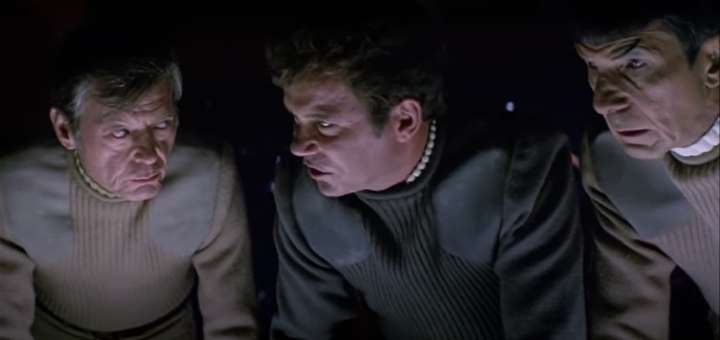 Still from Star Trek V: Kirk, Sybok and Spock peer down at something