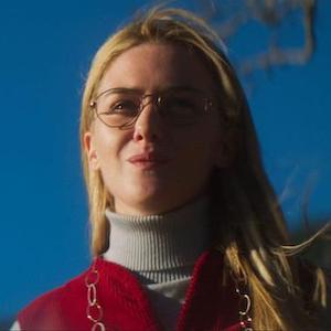 Still from When I'm a Moth: a young woman in glasses and a turtleneck gazes upward