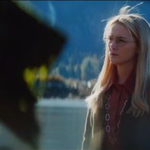 Still from When I'm A Moth: a young woman in glasses looks out over a lake