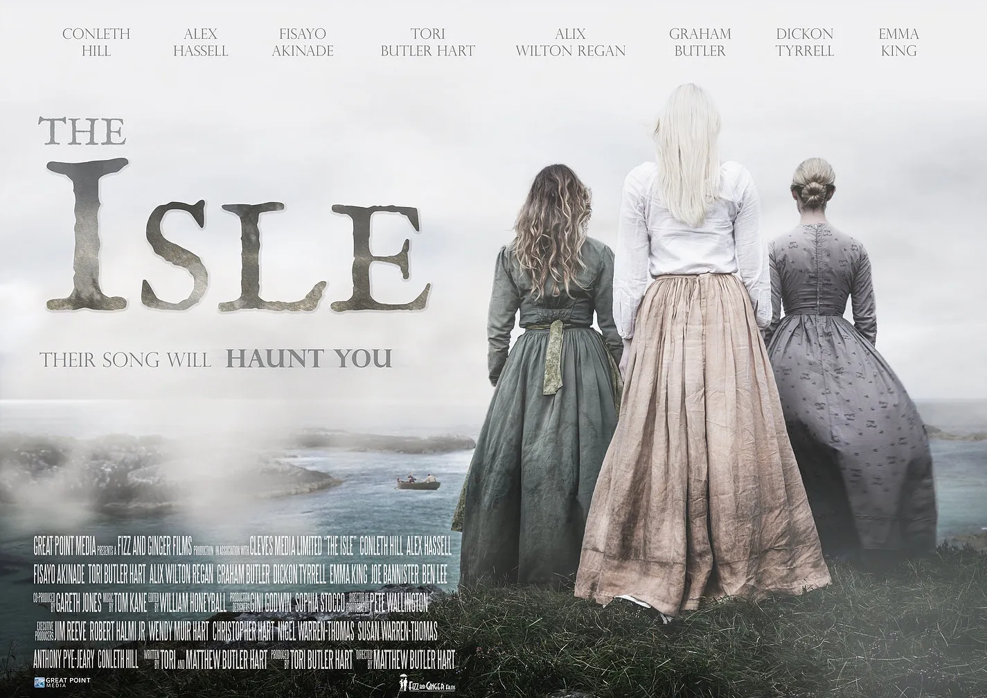 Poster for The Isle: three women in long dresses stand on a misty cliff facing the sea