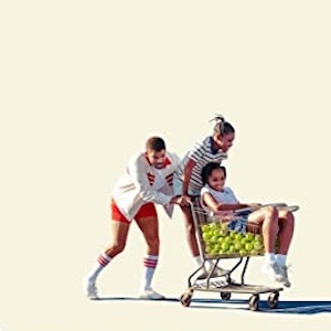 Poster art for King Richard: a father pushes his two daughters in a shopping cart full of tennis balls