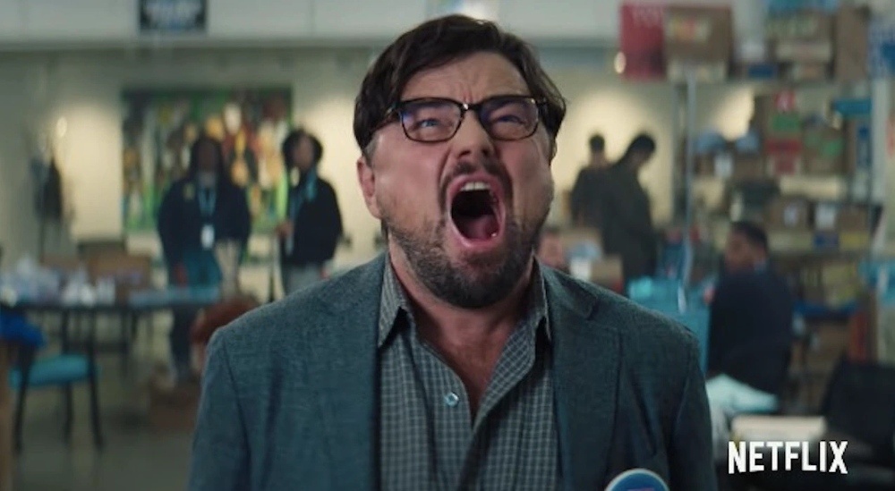 Still from Don't Look Up: Leonardo DiCaprio in glasses screams in frustration in a busy office