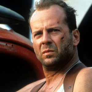 Bruce Willis in Die Hard with a Vengeance, bruised and in a sweaty vest