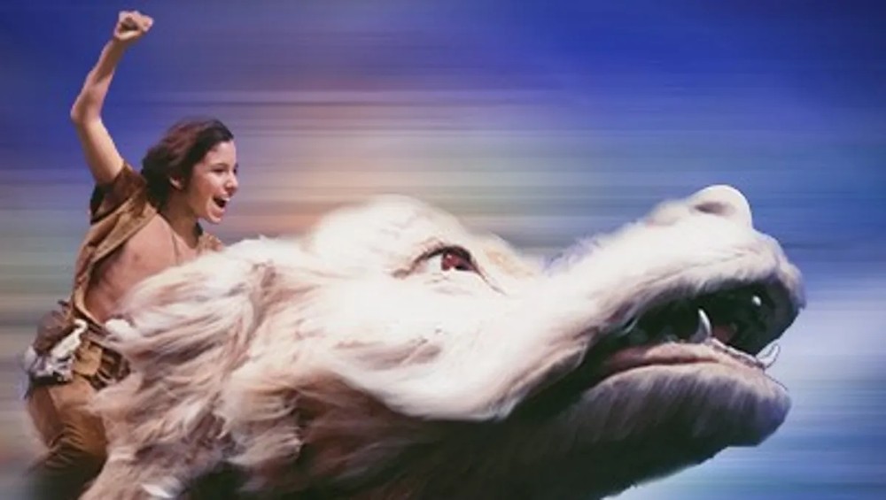 Still from The Neverending Story: Atreyu raises a fist while riding Falkor the luckdragon