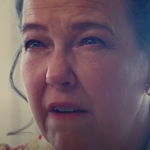 Close-up of a tearful woman's face, illustrating the power of faces on a big screen