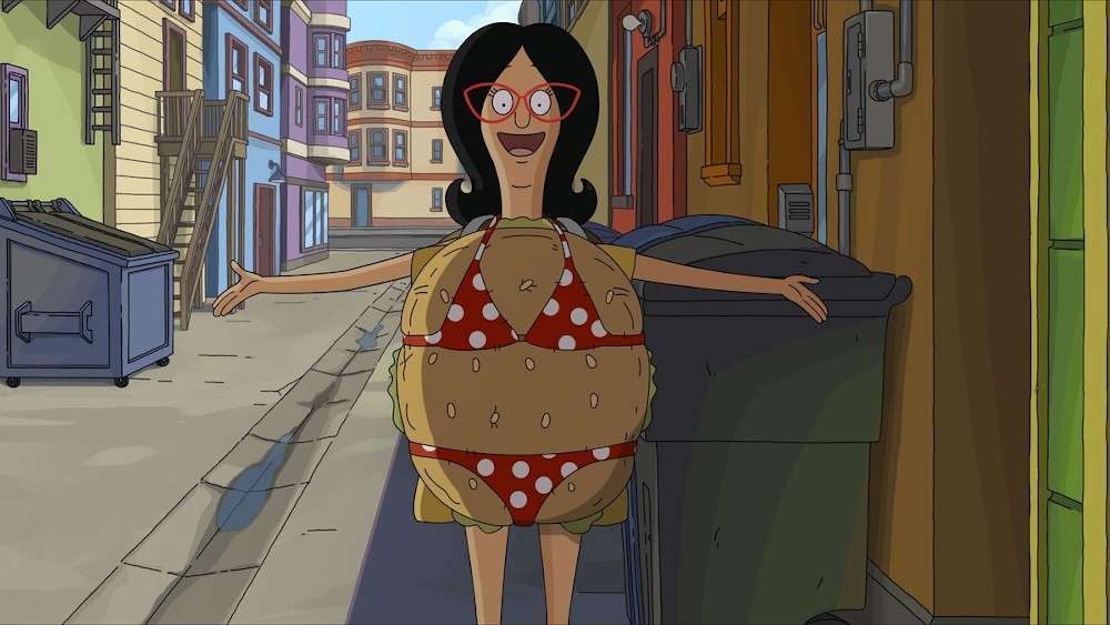 Still from The Bob's Burgers Movie: Linda Belcher dances in an alley wearing a burger costume