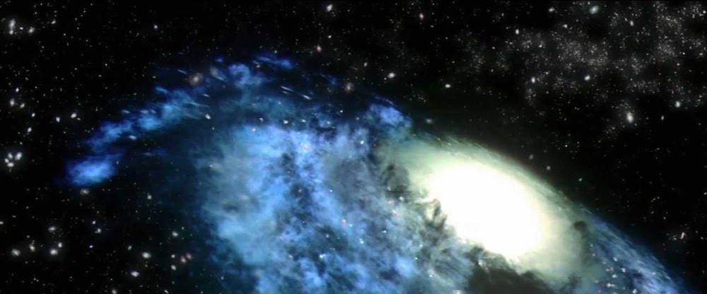 Still from Contact: the camera pulls back through space past a glowing blue galaxy