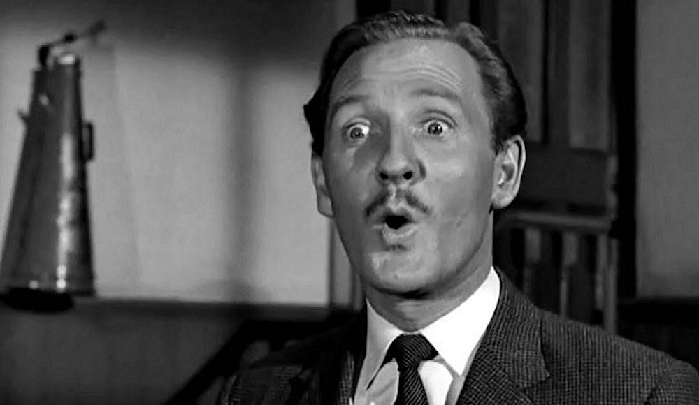 Black-and-white film still of Leslie Phillips, eyebrows raised in a mock-shocked expression