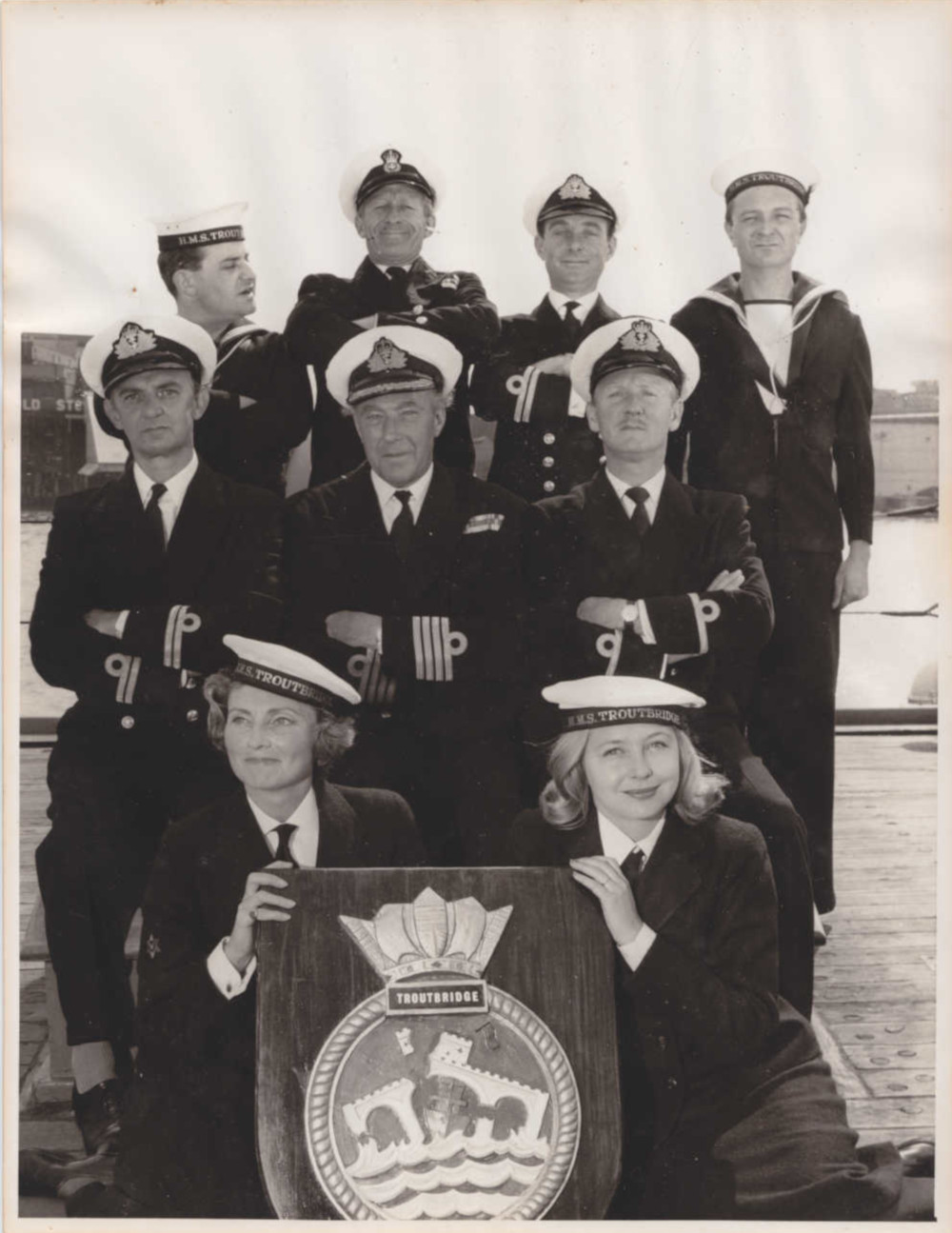 The Navy Lark cast photo: radio cast in naval uniforms with the HMS Troutbridge crest