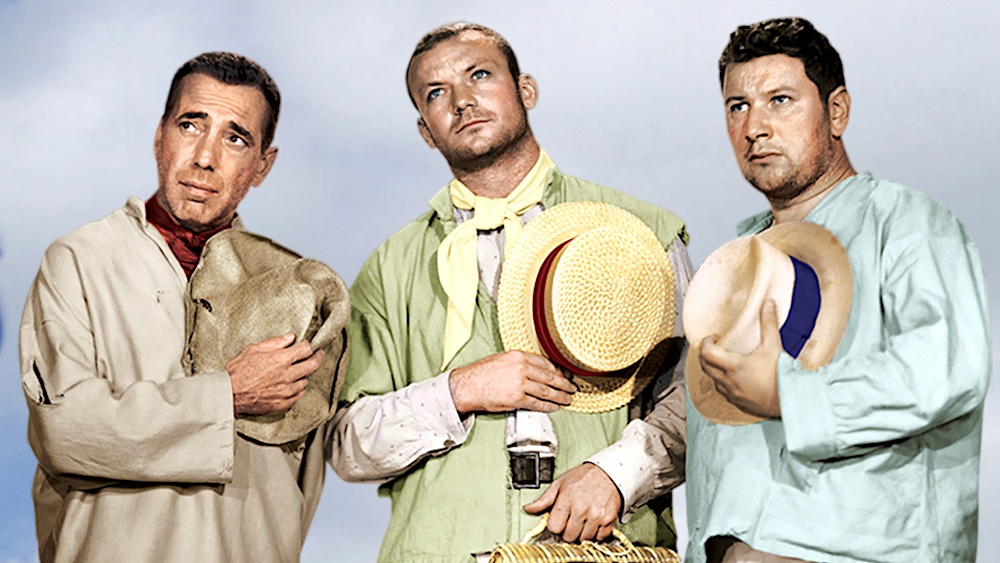 Still from We're No Angels (1955): three convicts in rough clothes stand holding straw hats to their chests