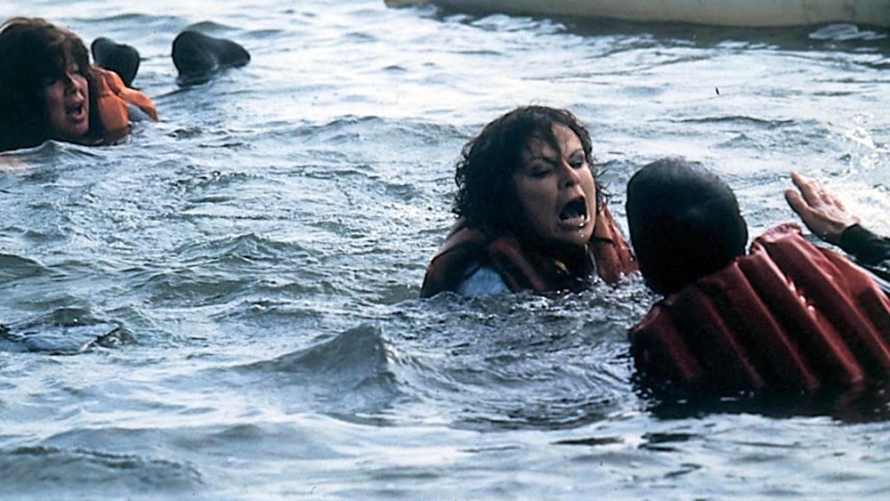 Still from She'll Be Wearing Pink Pyjamas (1985): women in life jackets struggle in choppy water