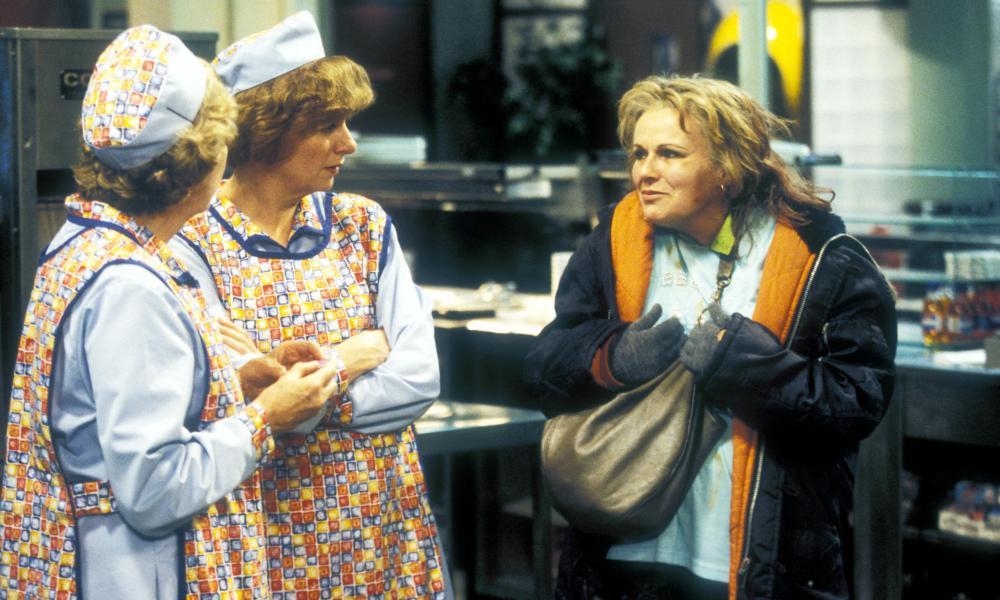 Julie Walters and Victoria Wood in dinnerladies: two canteen workers in tabards talk with a woman in a coat