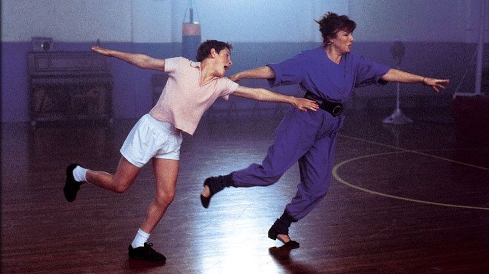Billy Elliot (2000): Julie Walters and Jamie Bell dance side by side in a gym