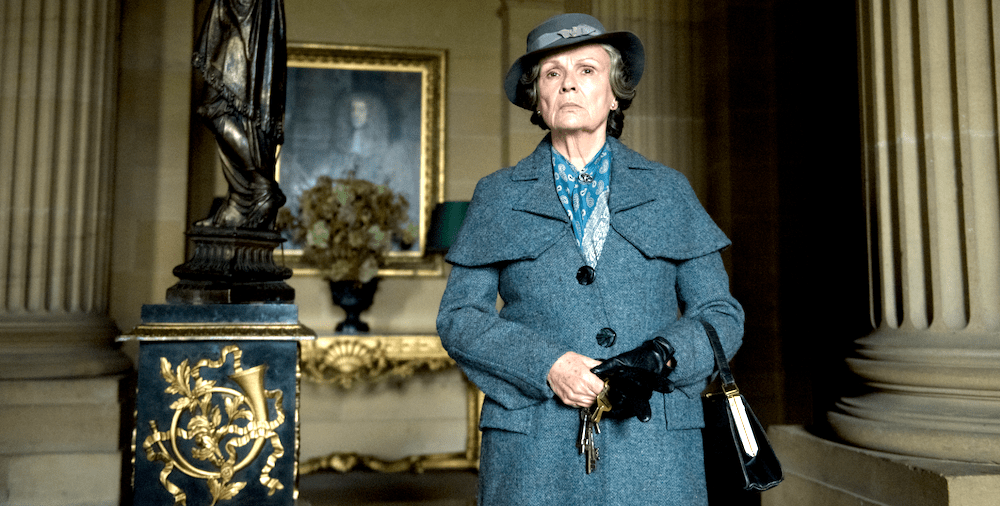 Still from The Secret Garden (2020): Julie Walters as the housekeeper, holding keys in a grand hall