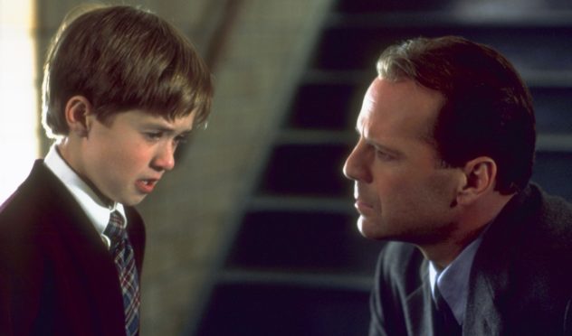 Still from The Sixth Sense: a tearful boy talks with a serious-looking man