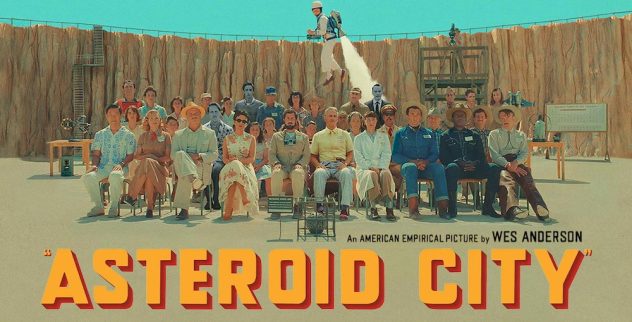 Banner for Asteroid City: the cast seated in rows in a desert crater as a man flies overhead with a jetpack