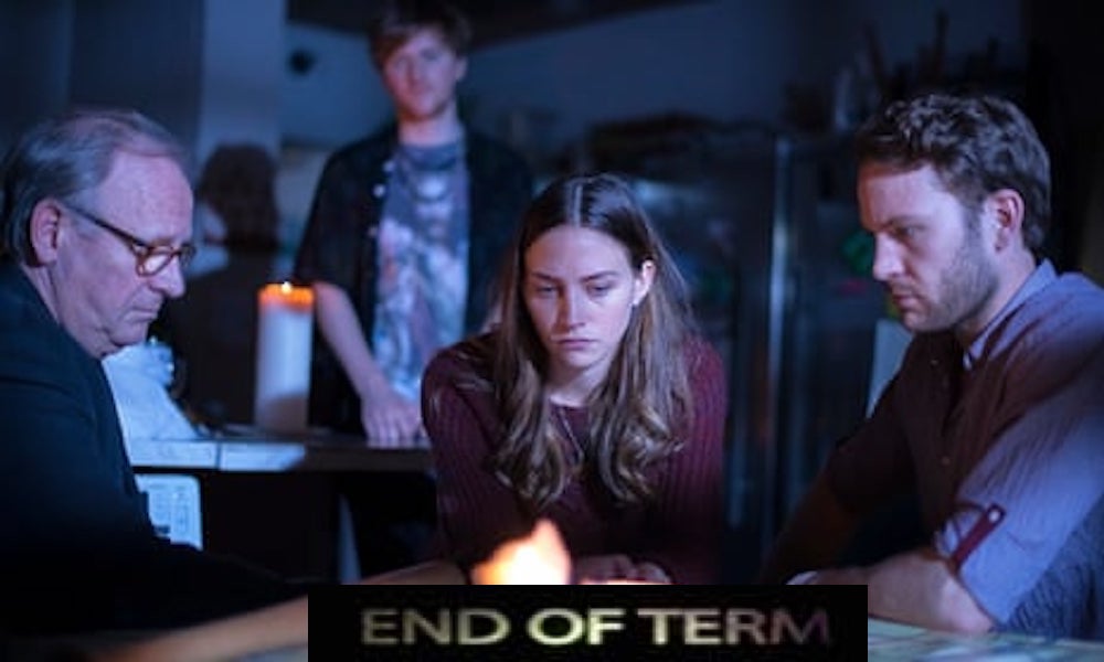 Still from End of Term: four people gather around a candlelit table