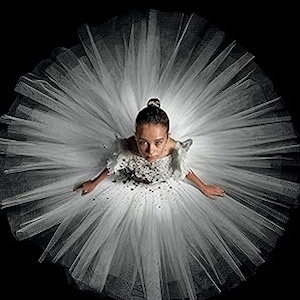 Abigail: a young ballerina in a white tutu, seen from directly above, looks up