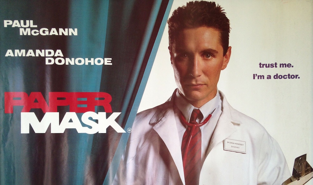 Poster for Paper Mask: Paul McGann as a young man in a doctor's white coat beside "Trust me. I'm a doctor."