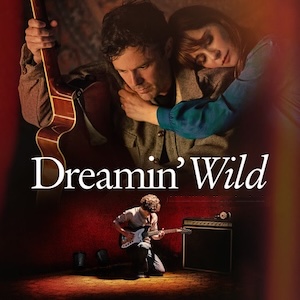 Poster for Dreamin' Wild: a man with a guitar hugged by a woman, above a young guitarist playing on a stage